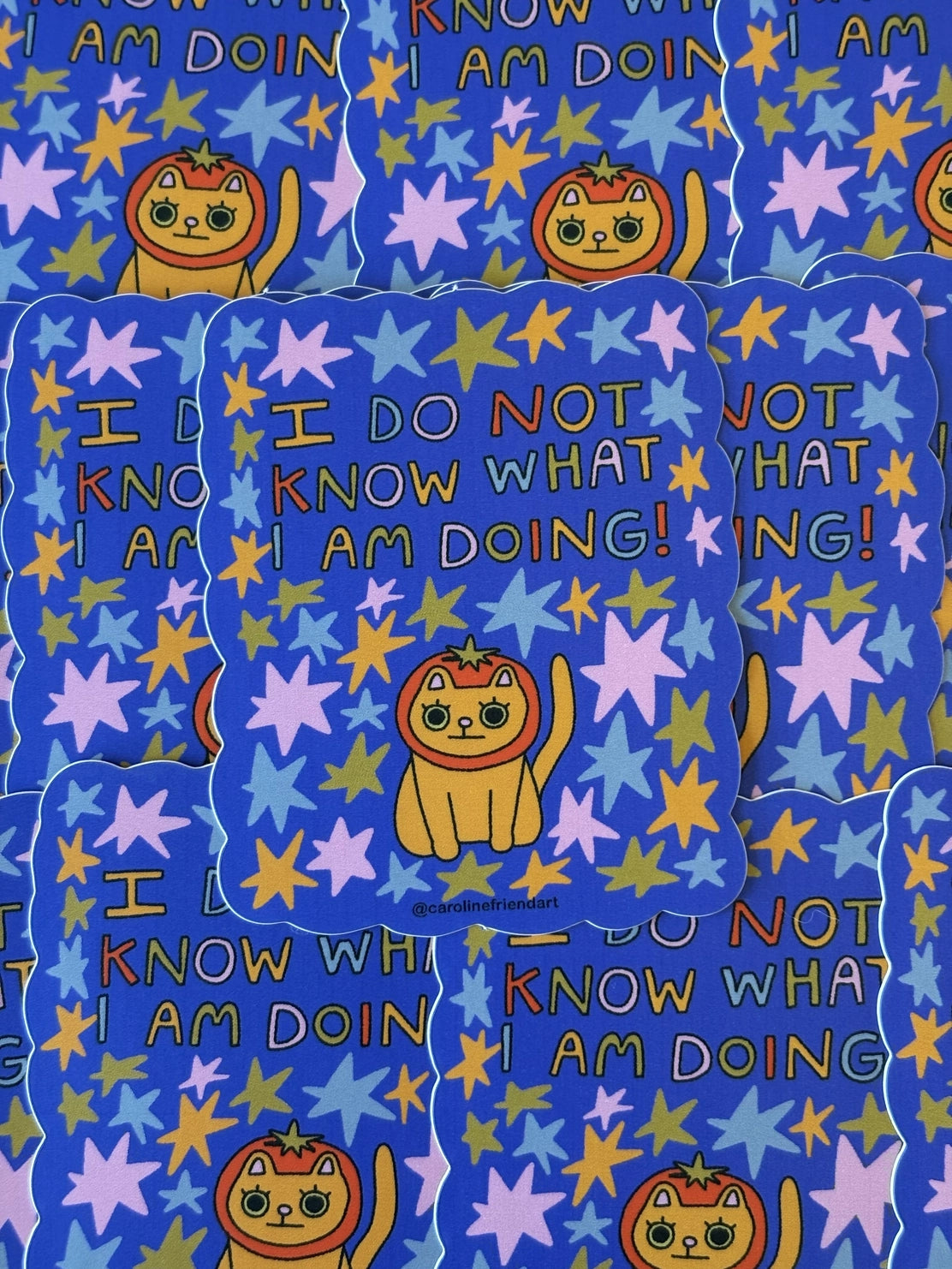 Patterned fabric with cartoon cat, stars, and text on a blue background