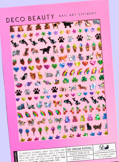 Sheet of nail art stickers with various designs on a pink background
