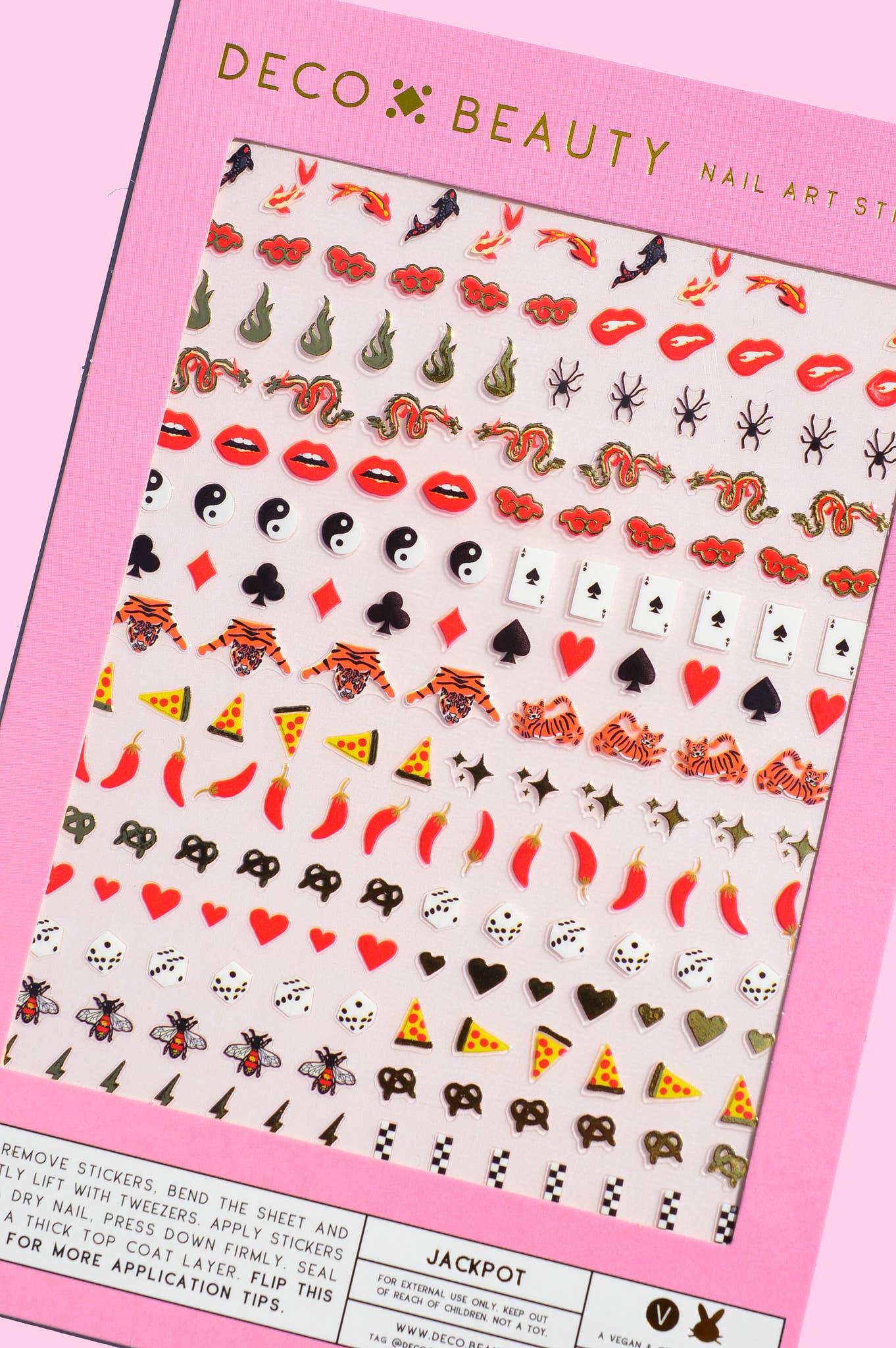 Sheet of nail art stickers with various designs on a pink Deco Beauty packaging.
