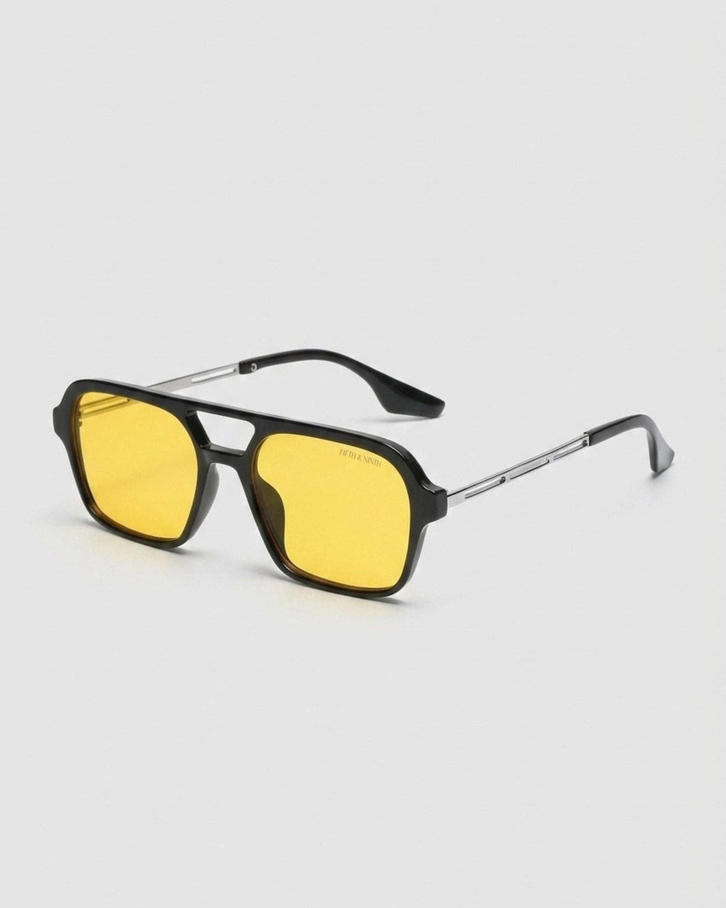 Sunglasses with yellow lenses and black frames on a white background