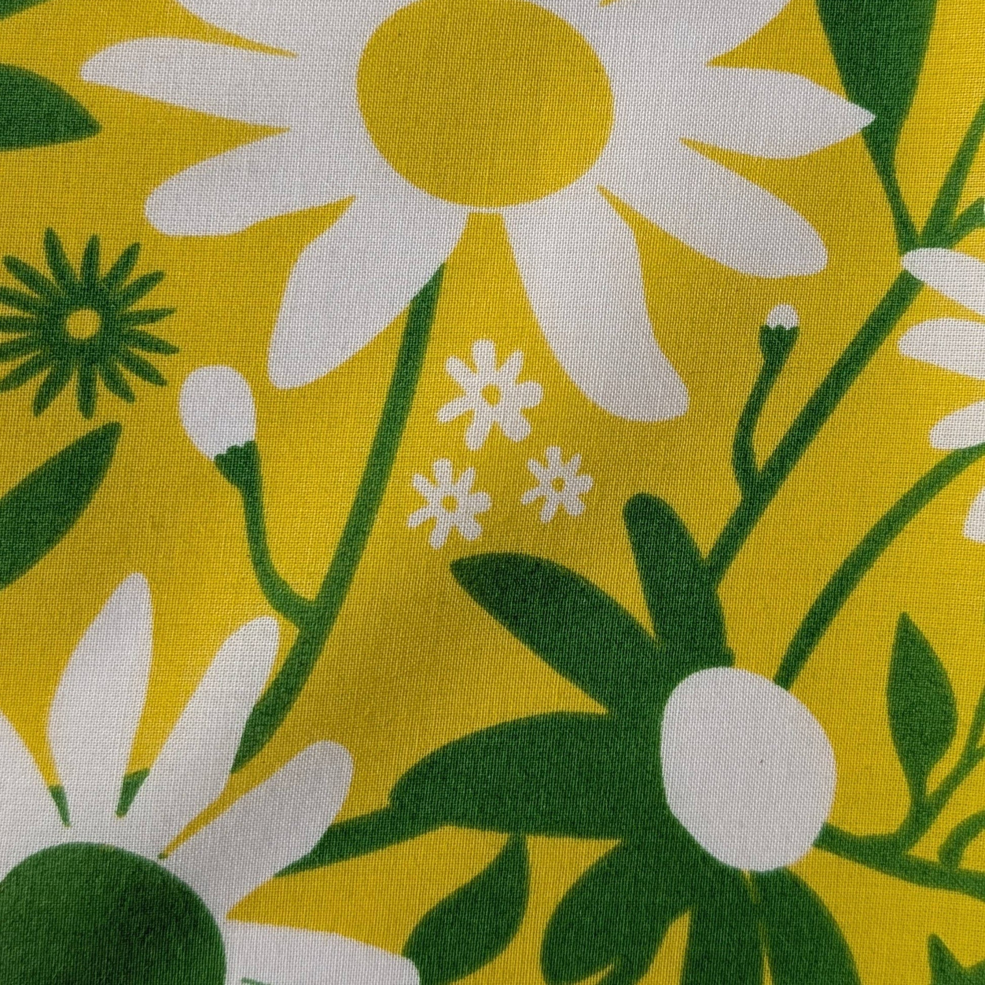 Floral pattern with white flowers and green leaves on a yellow background