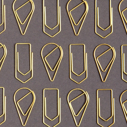 Pattern of gold paper clips on a gray background