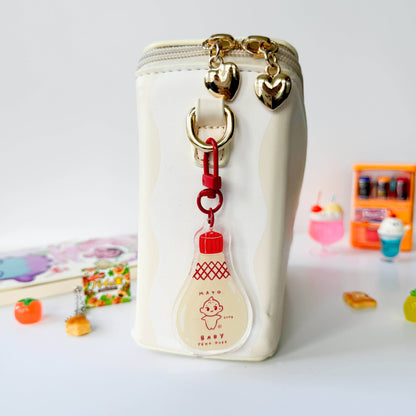White pouch with gold zipper and heart-shaped charms on a white background