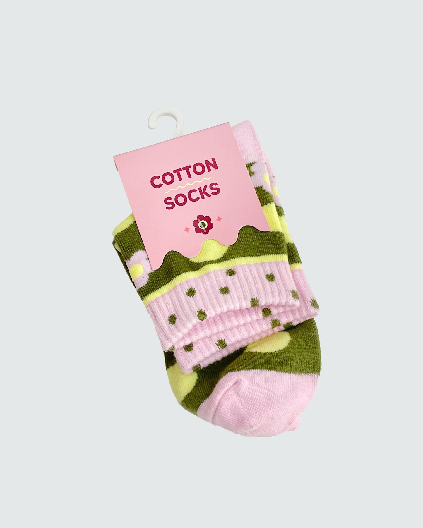 Pair of pink and green socks with a pink 'Cotton Socks' label on a light gray background