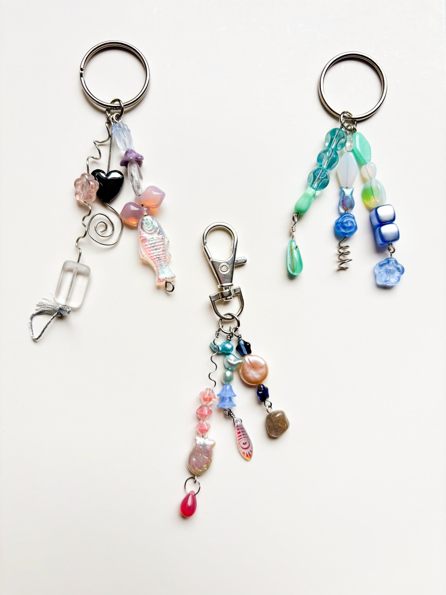 Three colorful beaded keychains on a white background