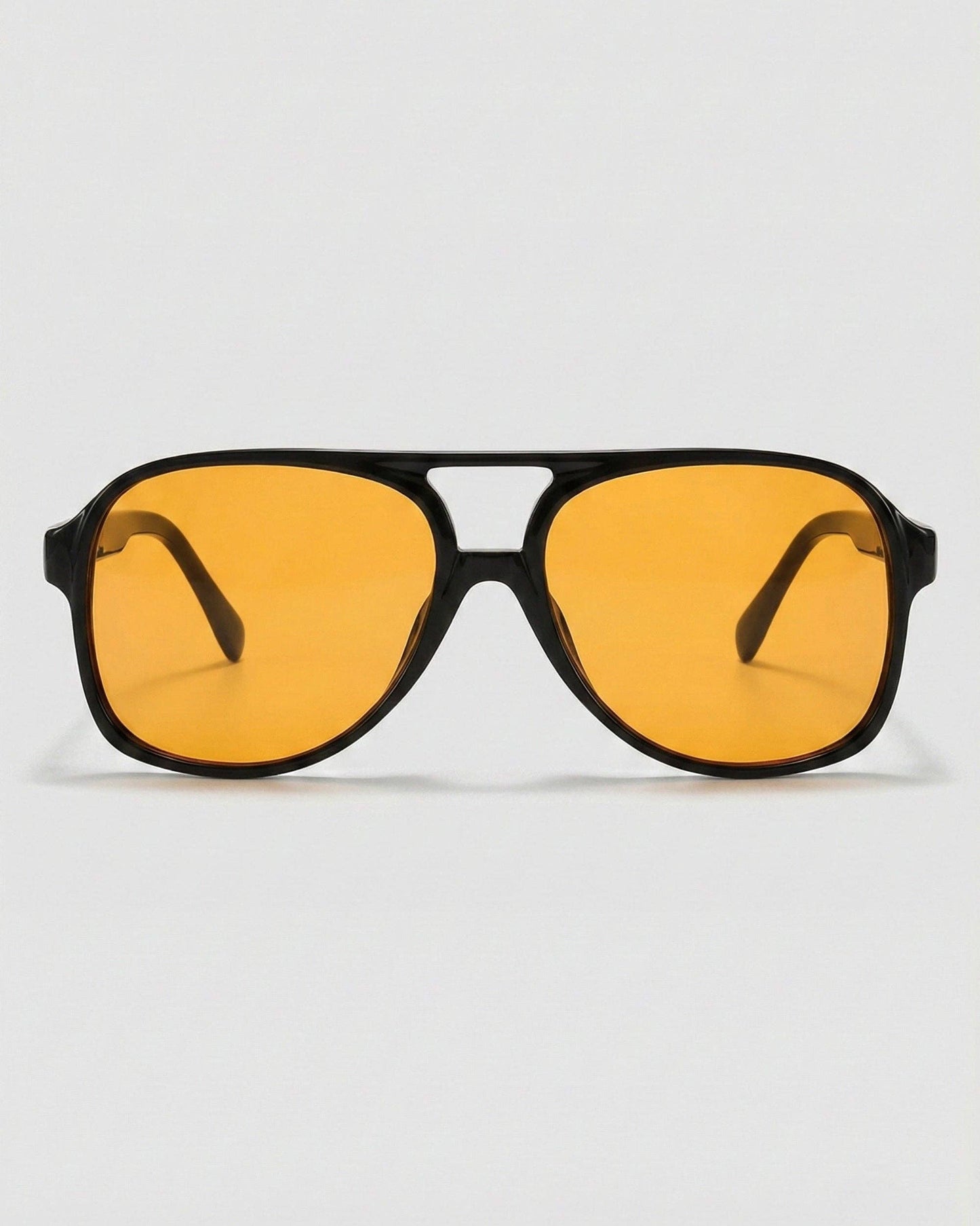Sunglasses with yellow lenses and black frames on a white background