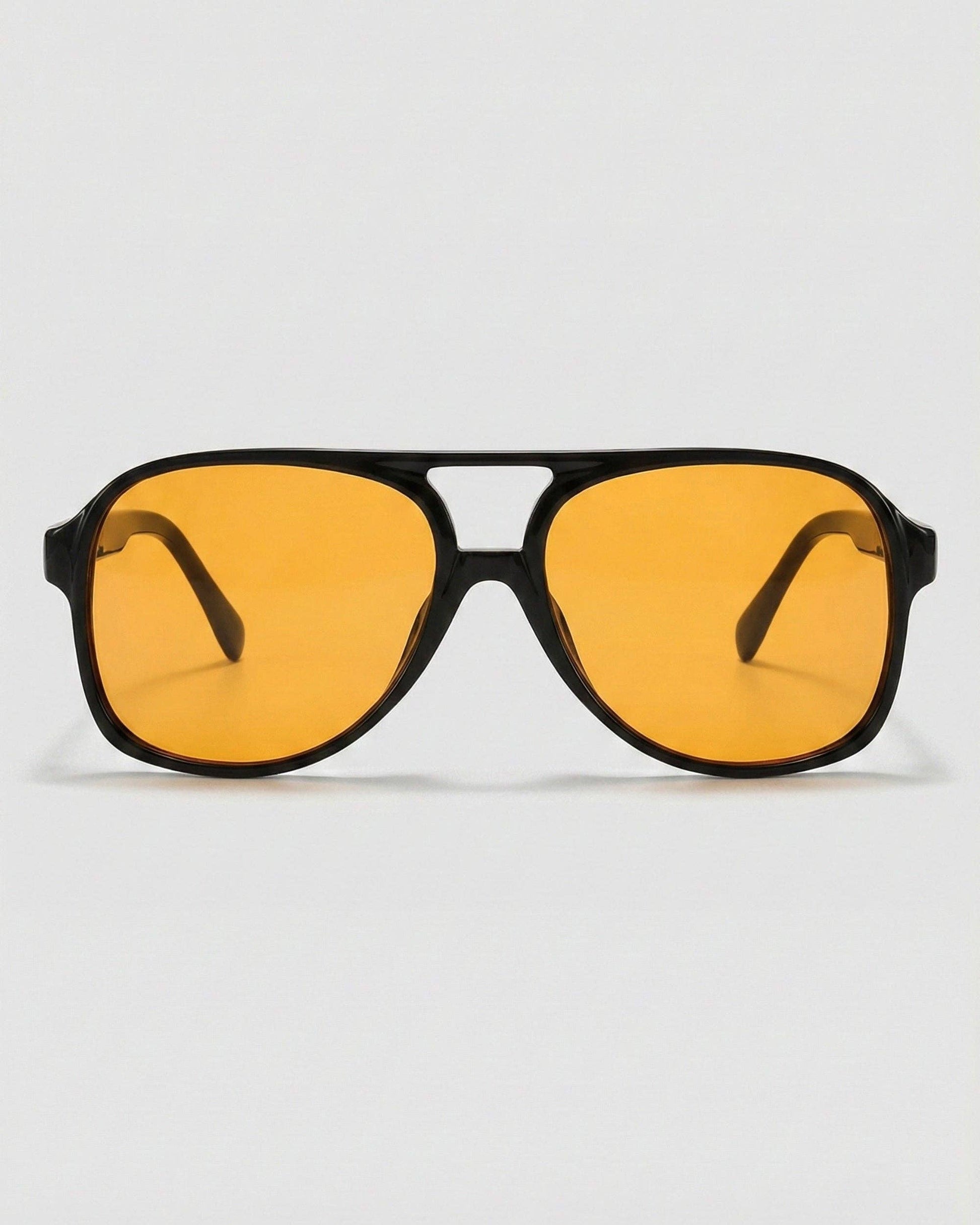 Sunglasses with yellow lenses and black frames on a white background