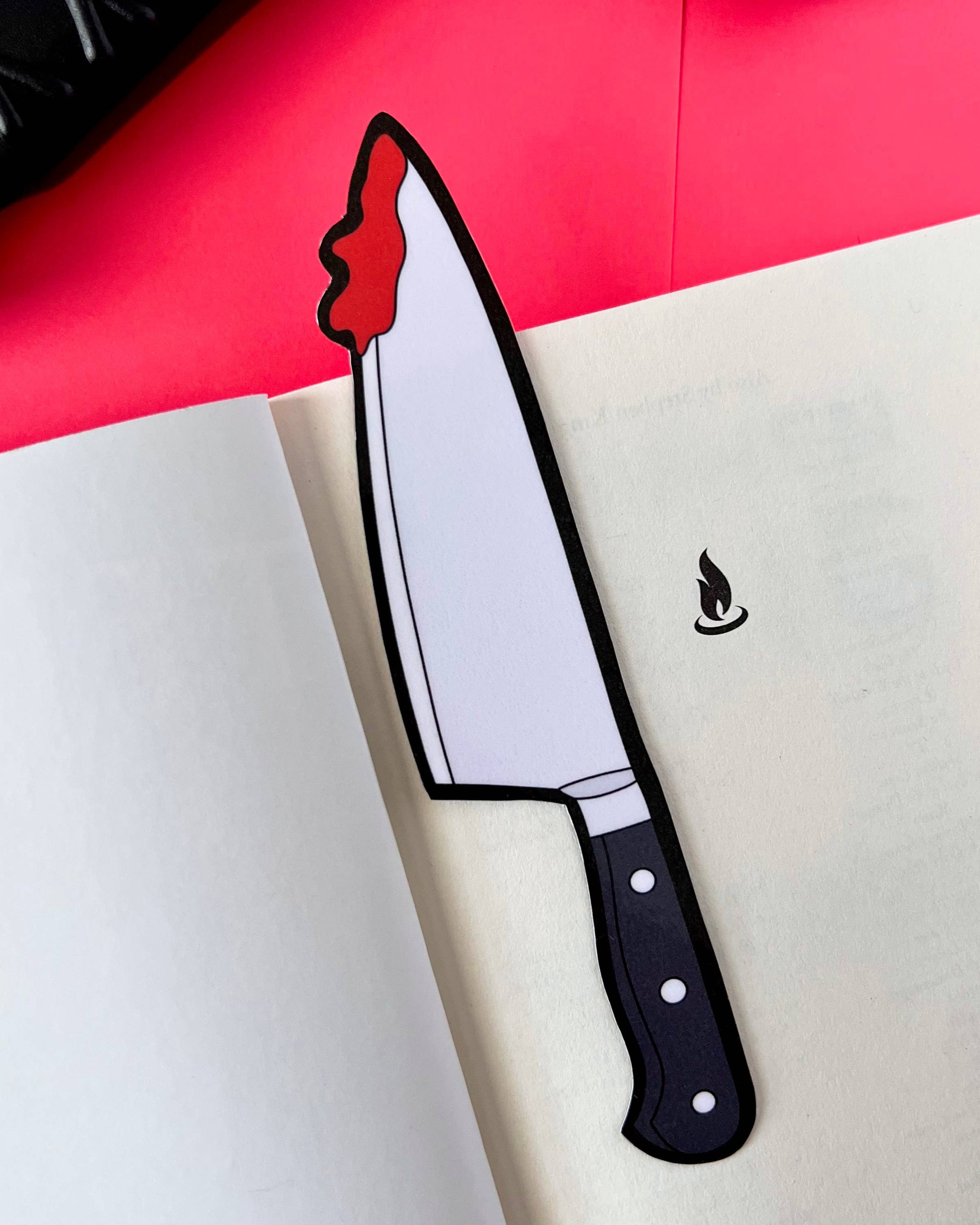 Illustration of a chef's knife with a black handle on a white surface with a red background.