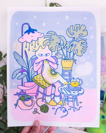 Knitting Kuni Riso Art Print, Illustration of a cat sitting with plants and yarn on a pastel background