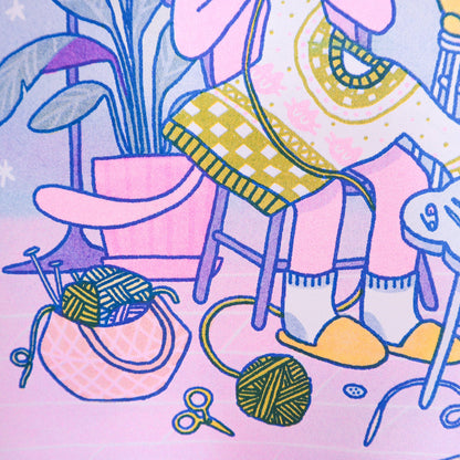 Knitting Kuni Riso Art Print Illustration of a cozy room with a chair, plant, and knitting supplies on a pink background