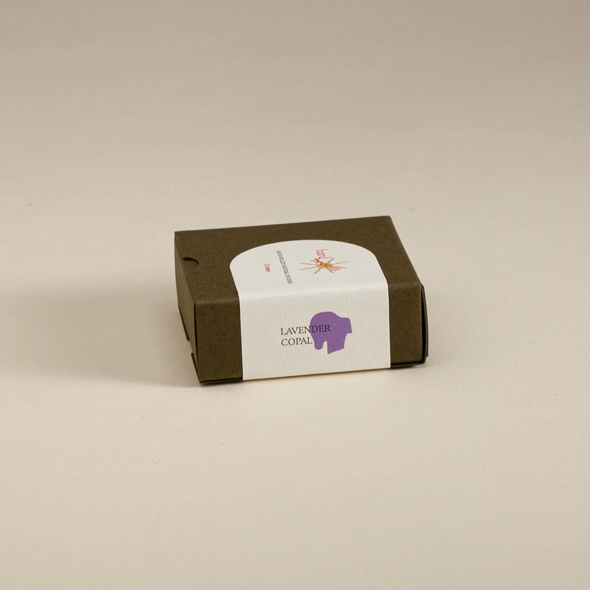 Small brown box with a white label on a beige background