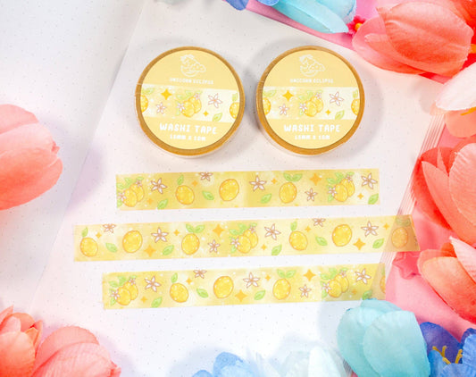Two round containers with a yellow label and decorative washi tape on a white background with colorful flowers.