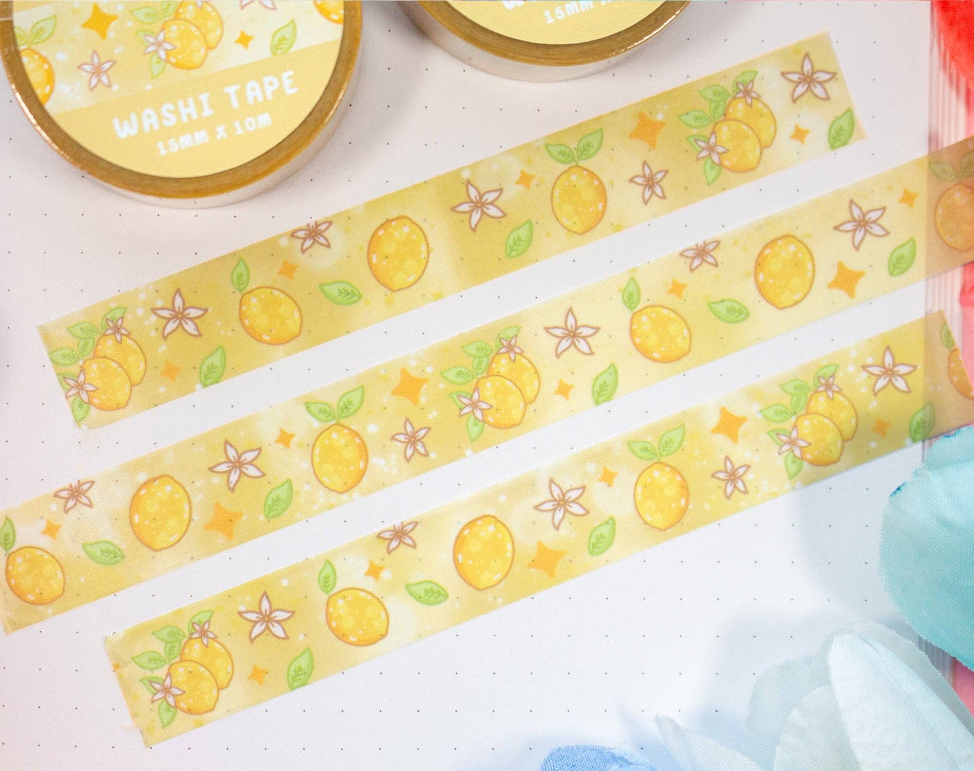 Decorative washi tape with lemon designs on a light surface