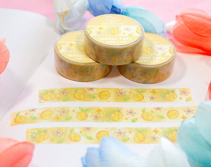 Round yellow containers with decorative tape featuring lemon designs on a colorful background.