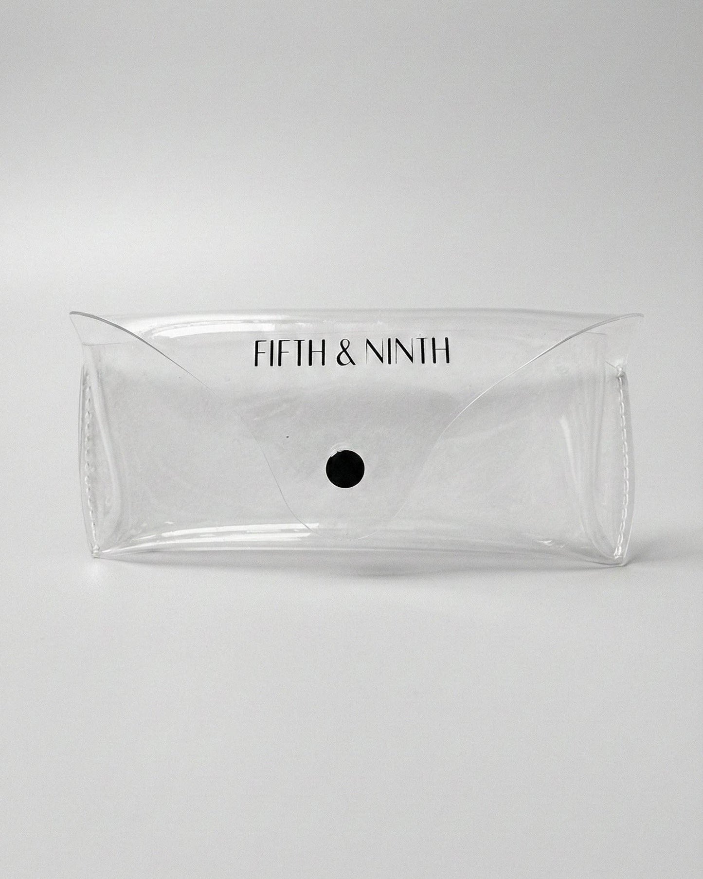 Clear pouch with 'Fifth & Ninth' branding on a white background