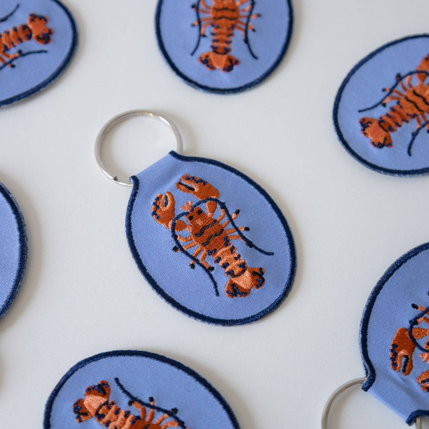 Keychains with lobster design on a blue background