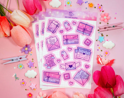 Sticker sheet with pink and purple designs on a pink background with flowers and hair clips.