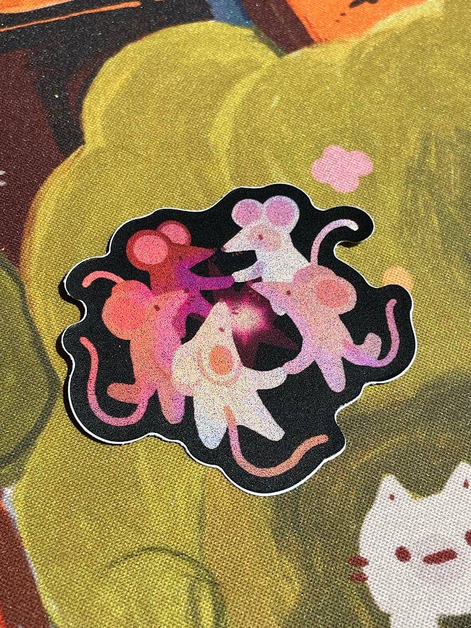 Colorful sticker of three cartoon mice on a textured background