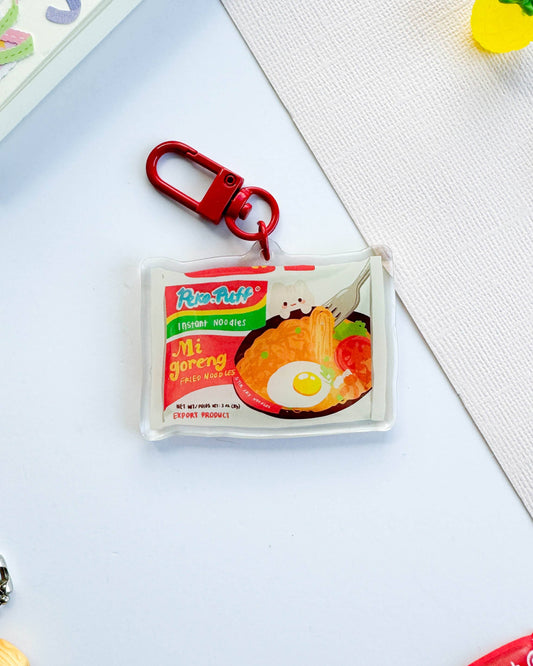 Keychain with a miniature package design on a light surface, Mie Goreng Ramen Noodles Keychain