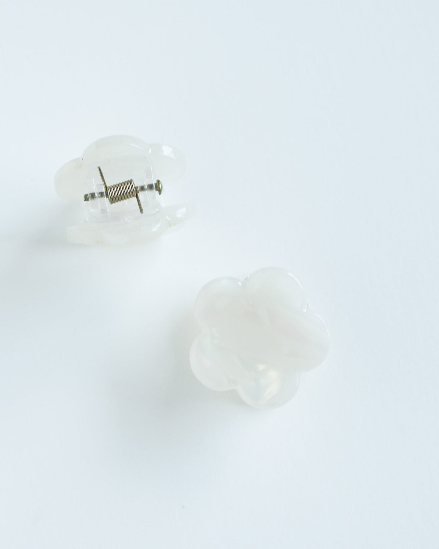 Mini Daisy Hair Claw Clip Pair of white hair clips with a small decorative element on a light gray background
