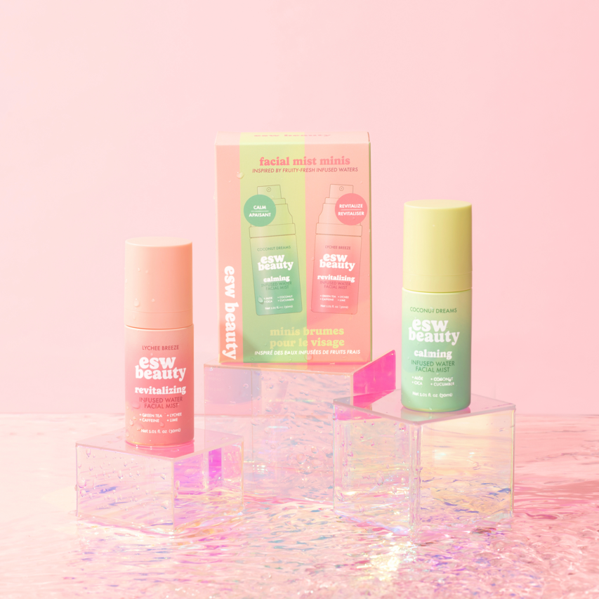 Skincare products with colorful packaging on a pink background