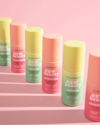 Collection of colorful 'esw beauty' products on a pink background