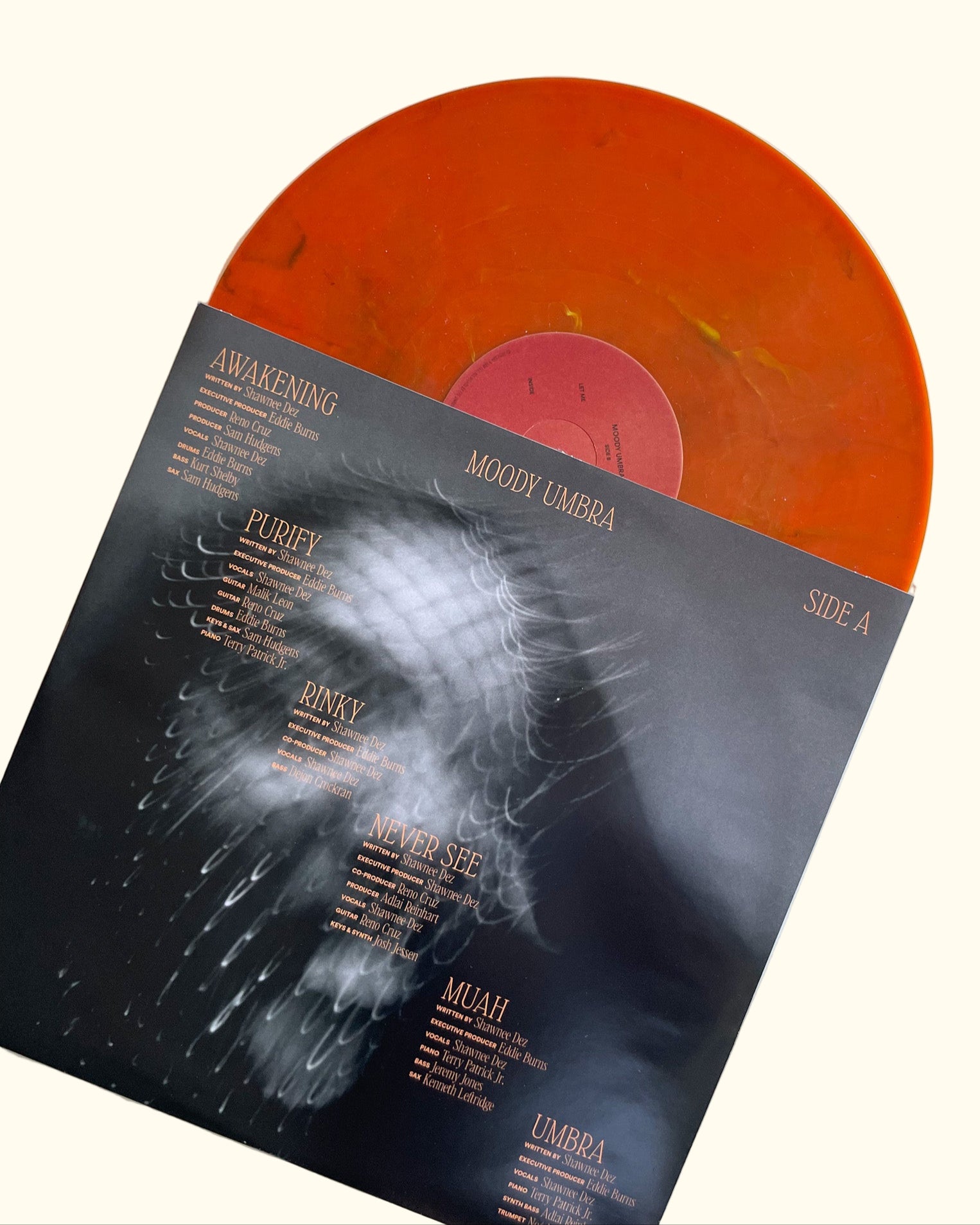 Orange vinyl record with a black cover featuring text and graphics on a white background, Moody Umbra Vinyl Record - Moody Umbra