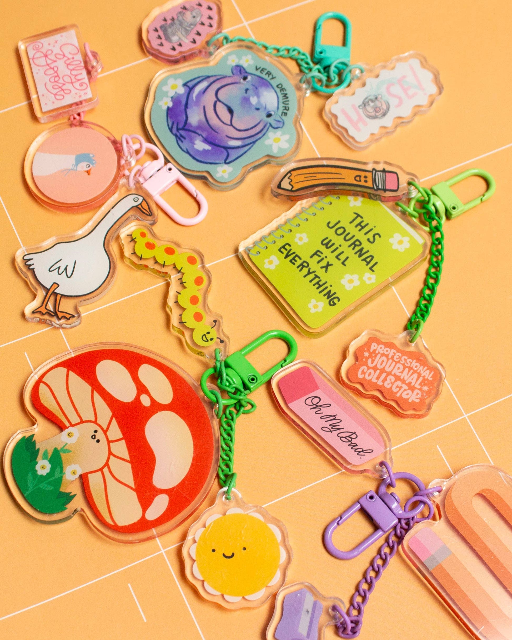 Collection of colorful keychains on a yellow grid background
