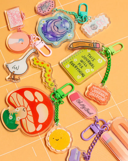 Collection of colorful keychains on a yellow grid background