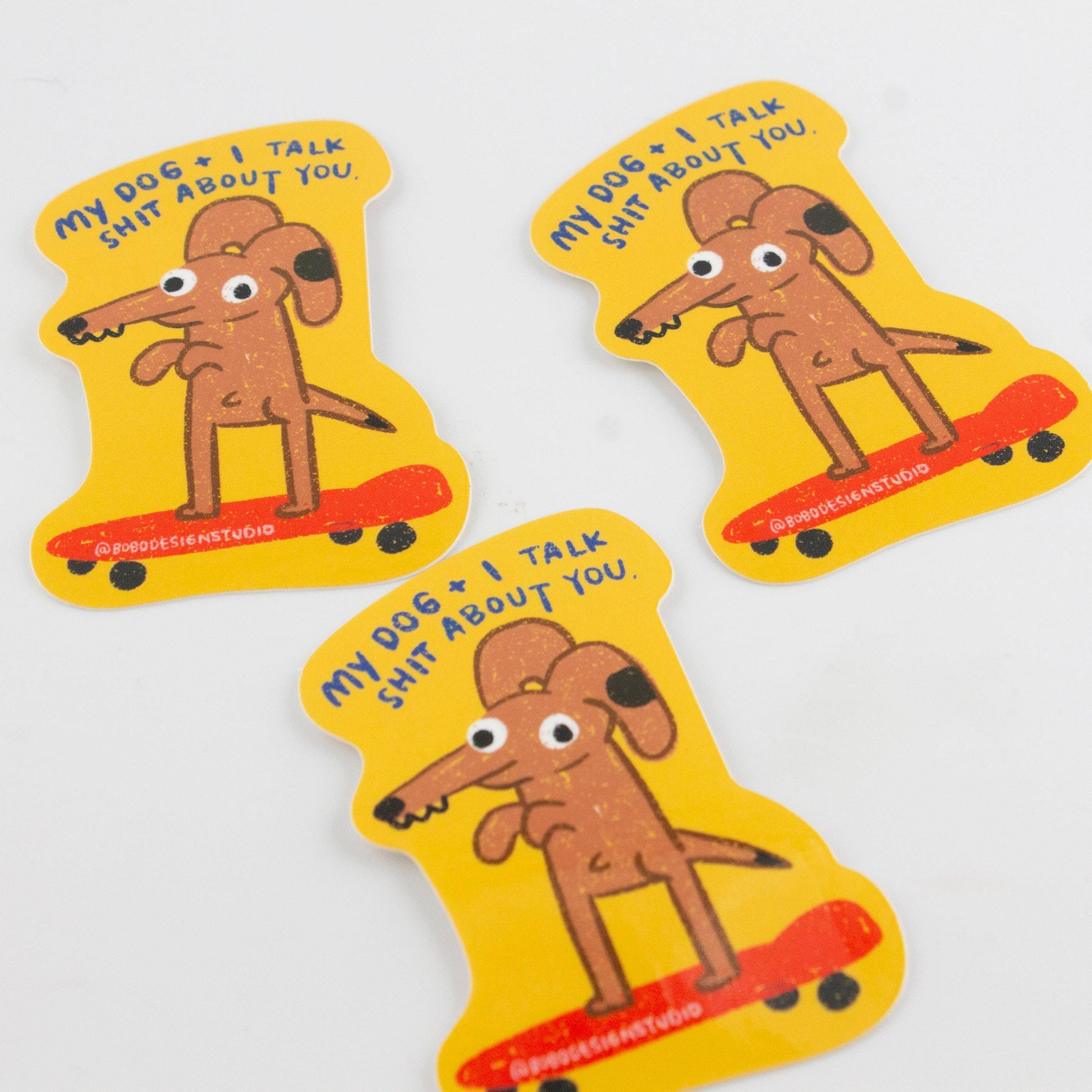 Three stickers with a cartoon dog and text on a white background