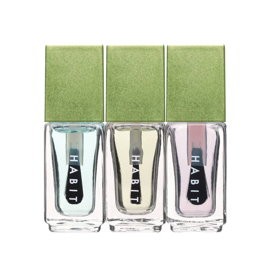 Three bottles of 'Habit' nail polish with a green box on a white background