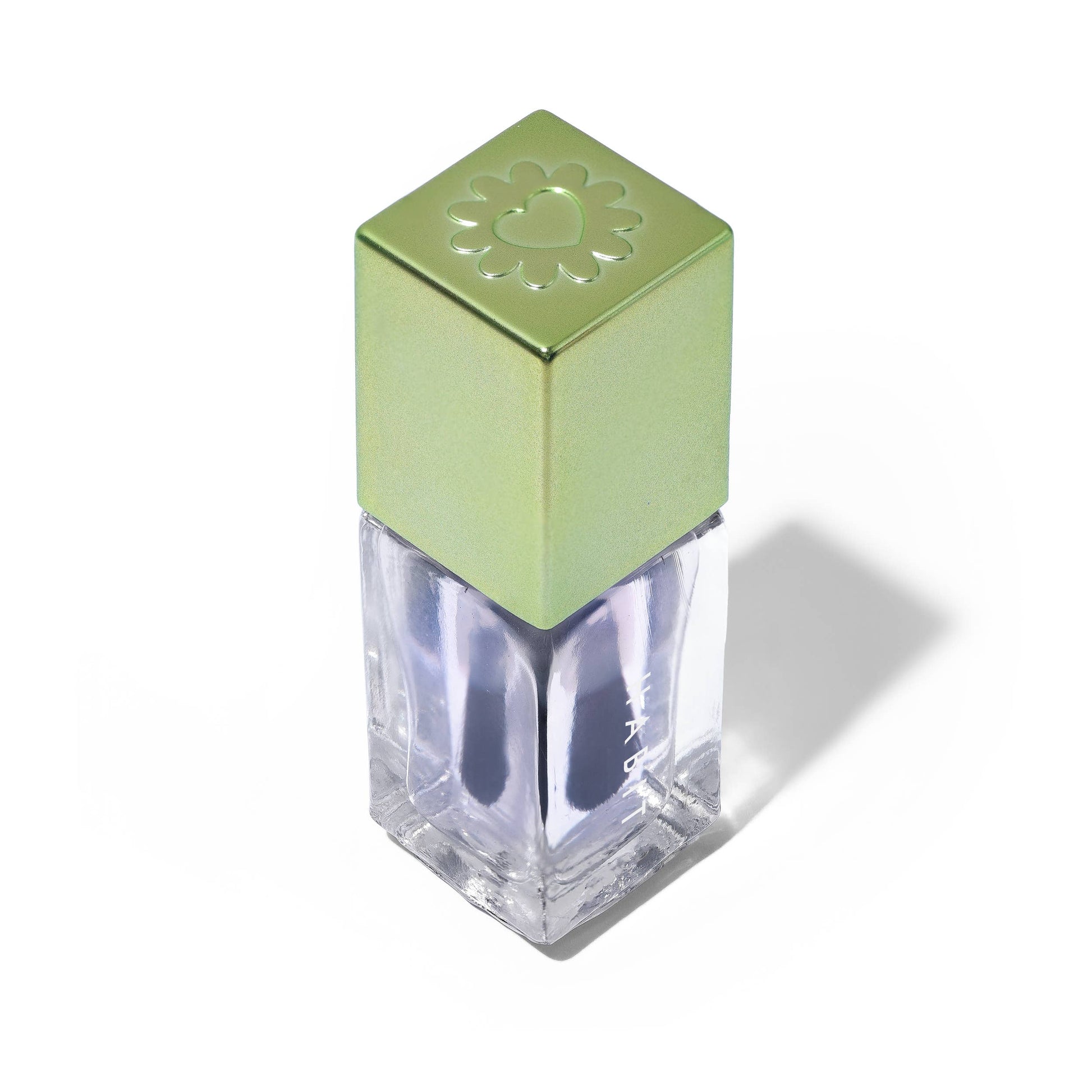 Green nail polish bottle with a clear base on a white background