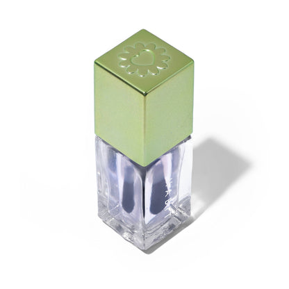Green nail polish bottle with a clear base on a white background