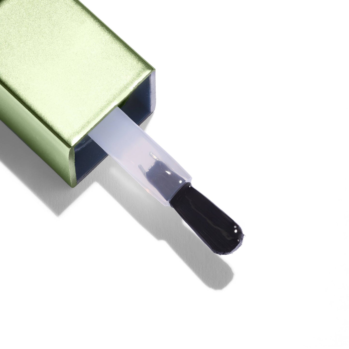 Makeup brush with green case on a white background