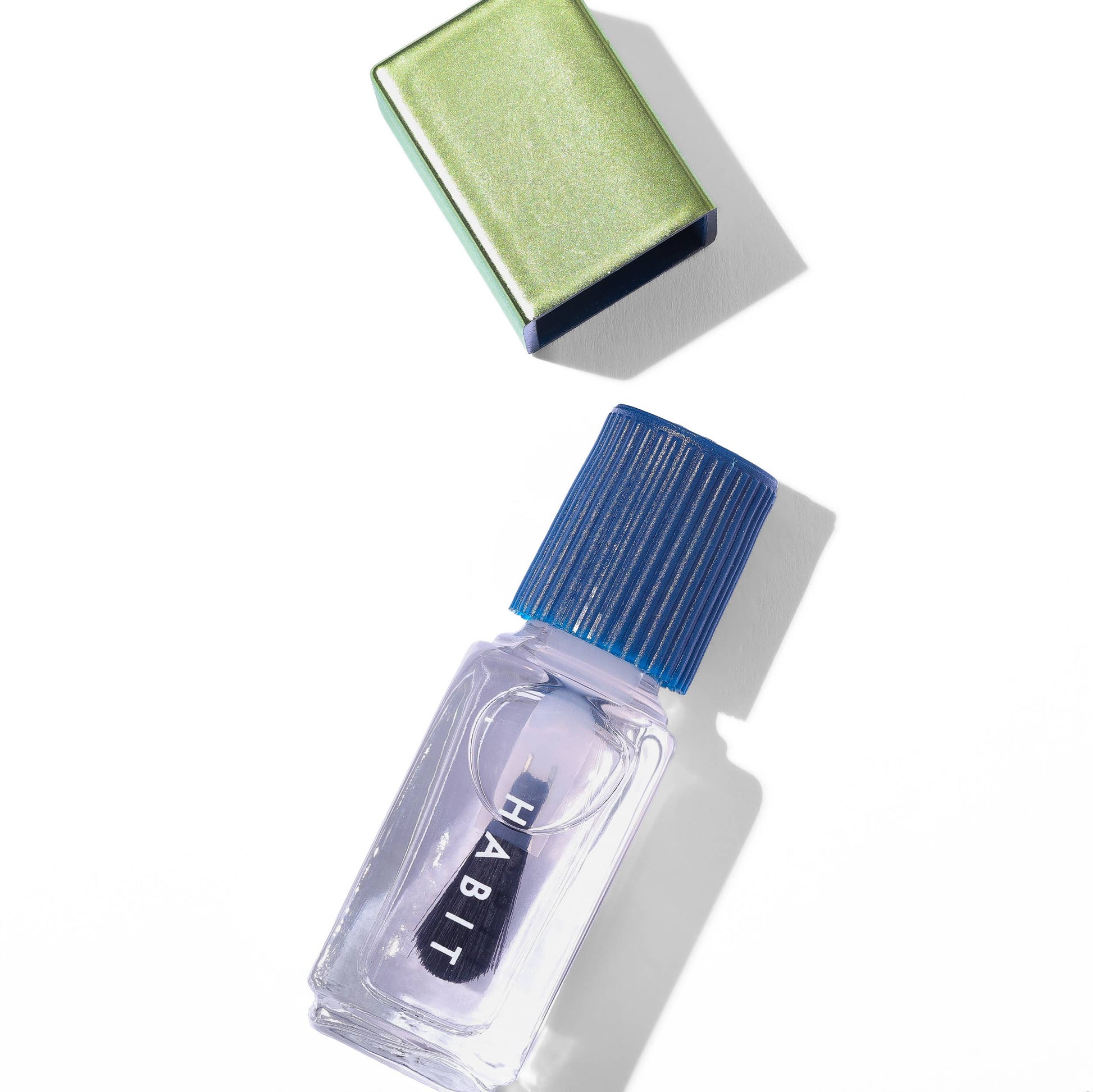 Small clear bottle with blue cap labeled 'Habit' on a white background