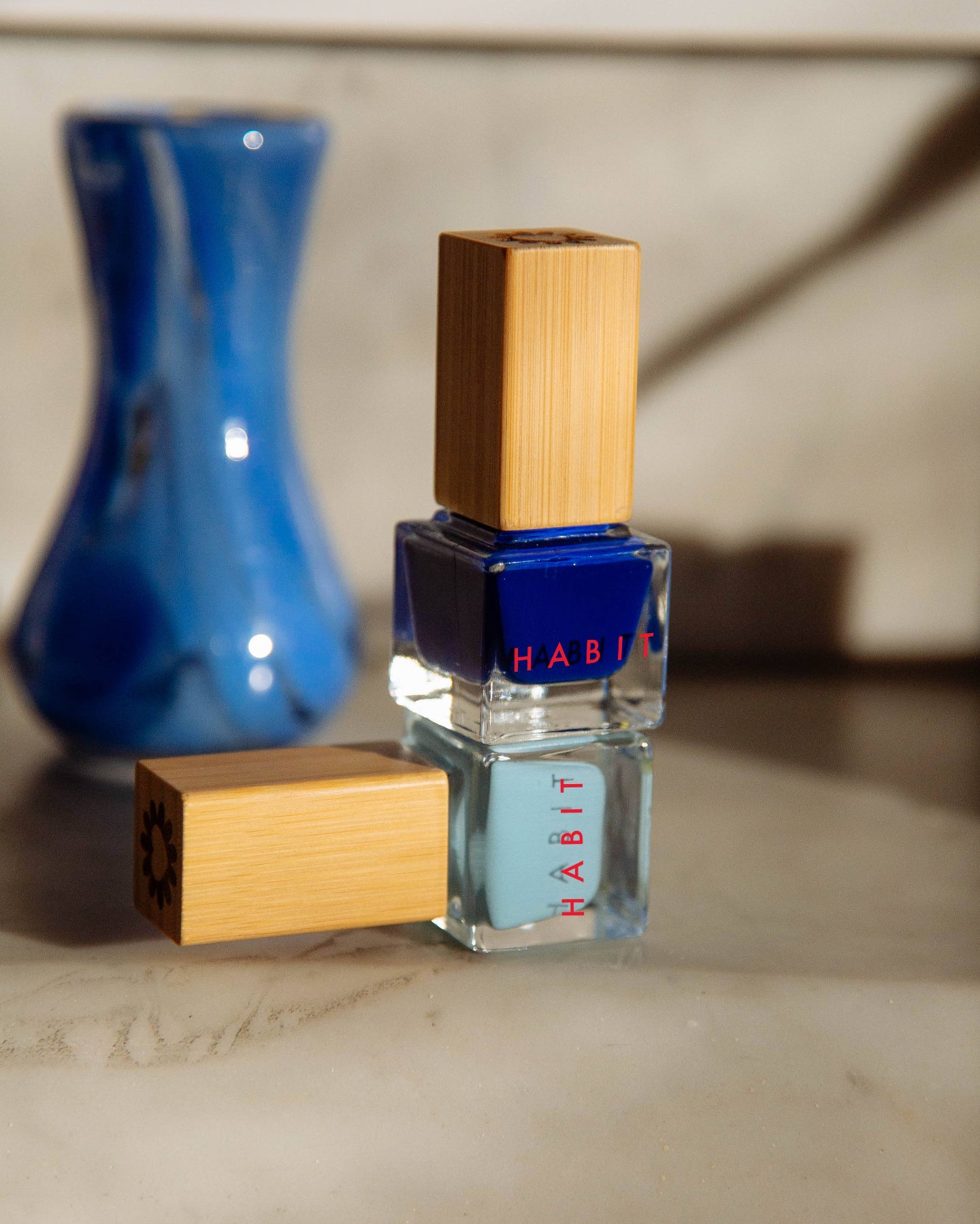 Nail polish bottle with wooden design on a marble surface, Night Drive Dark Blue Toxin Free Nail Polish