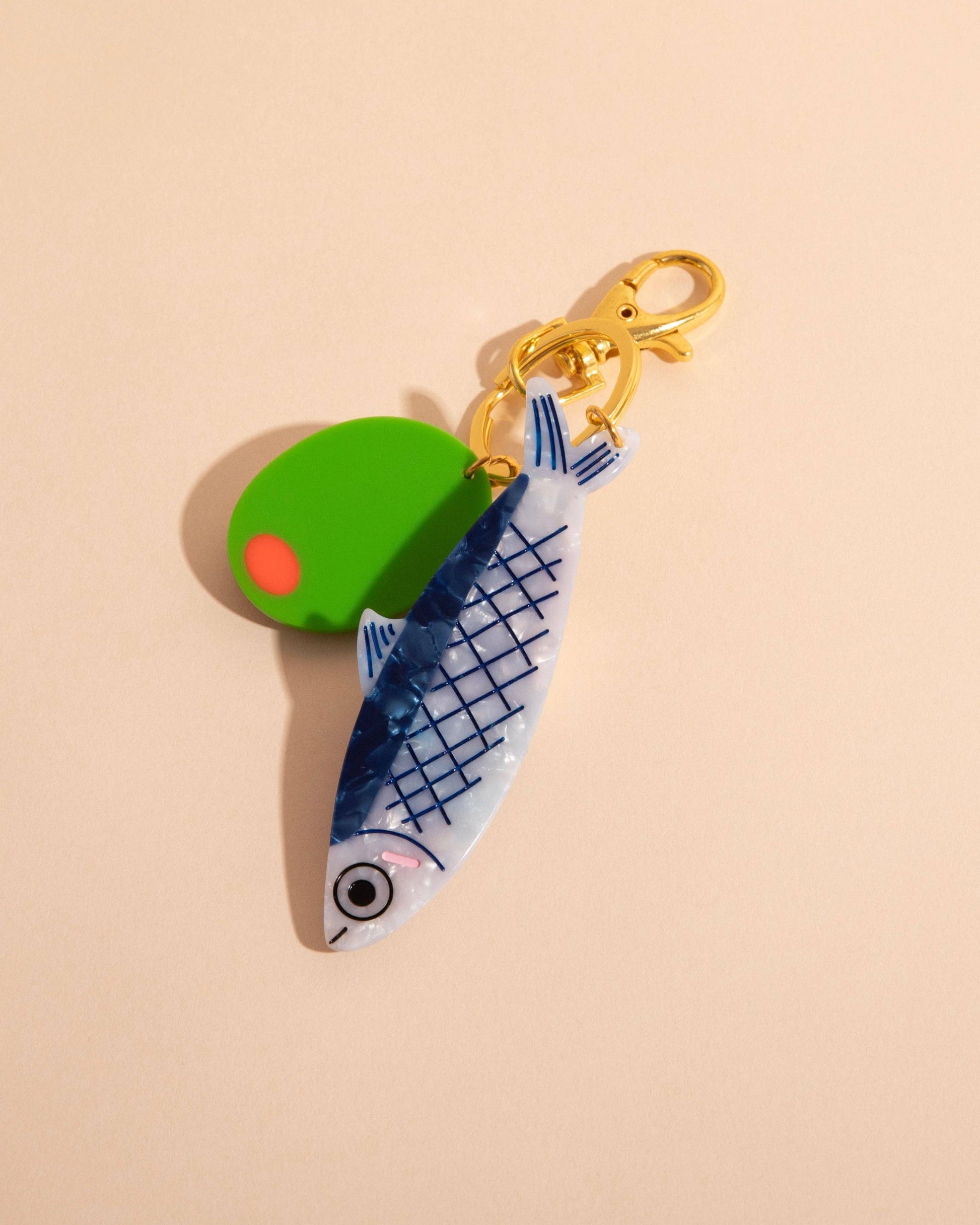 Keychain with fish design on a beige background