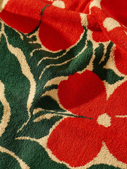 Close-up of a red floral pattern on a textured fabric background