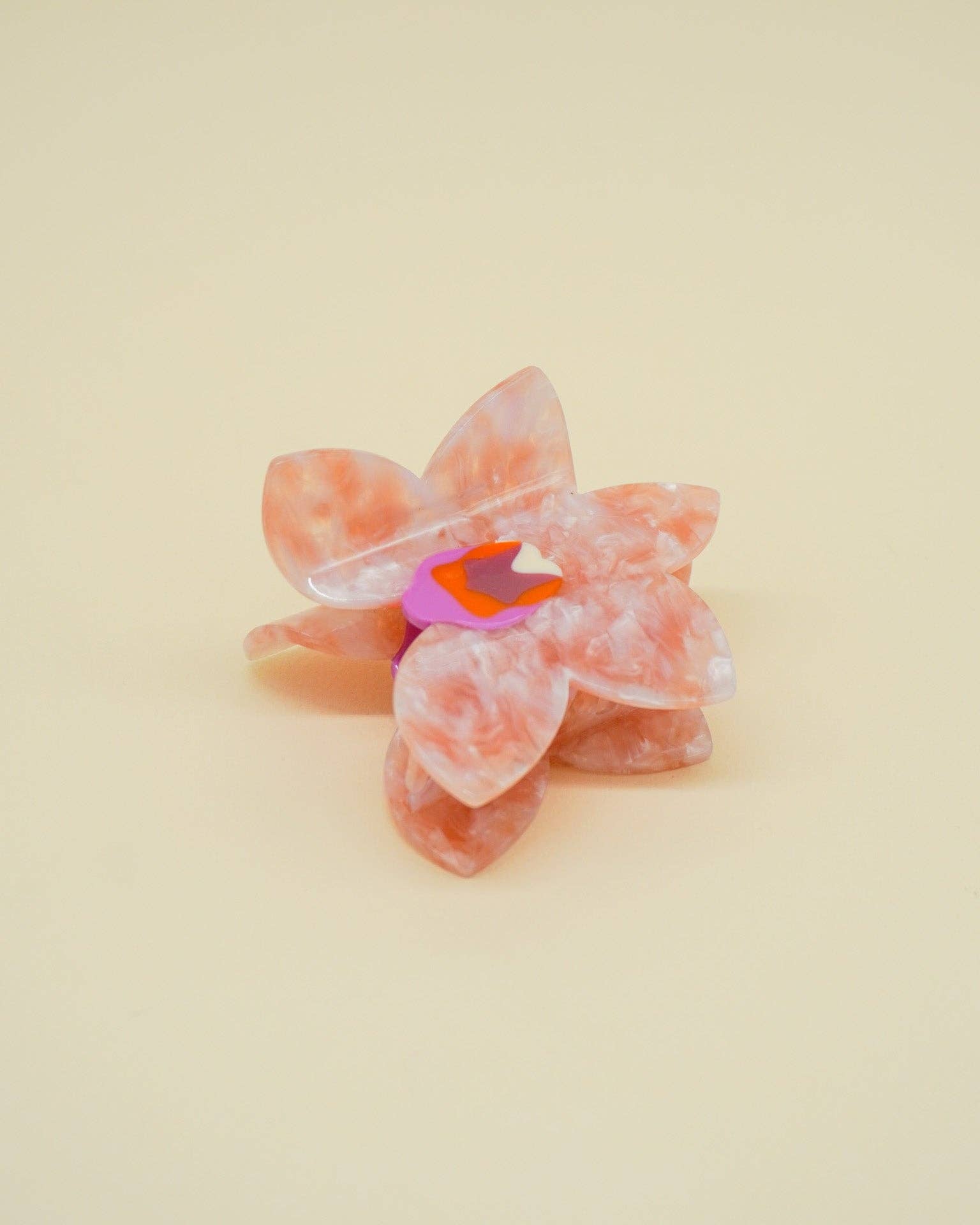 Pink butterfly hair clip on a beige background