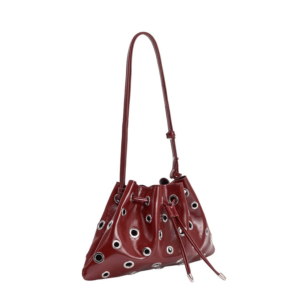Brown leather handbag with eyelet details on a white background