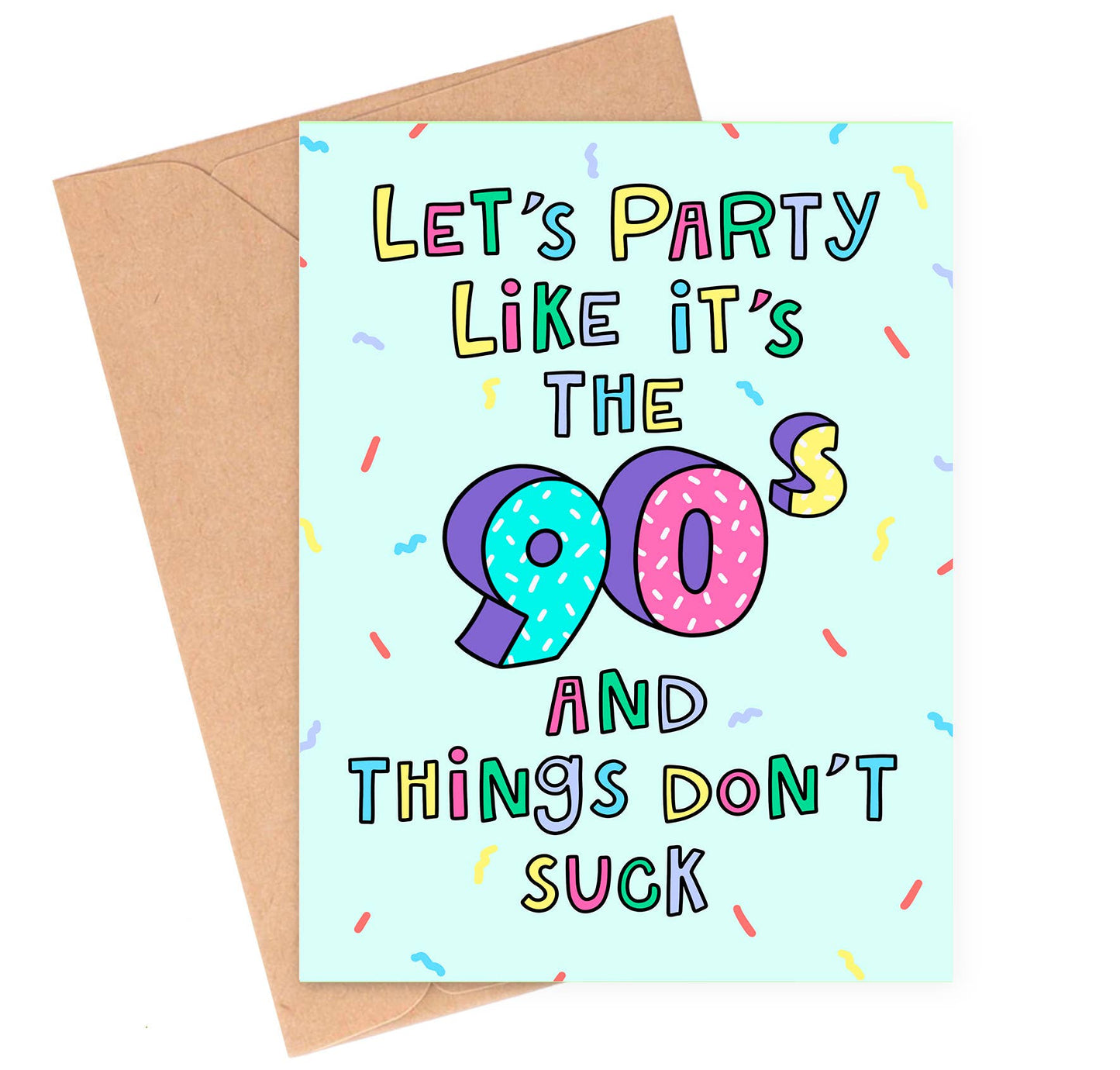Greeting card with colorful text 'Let's party like it's the 90s and things don't suck' on a light blue background with confetti, next to a brown envelope.
