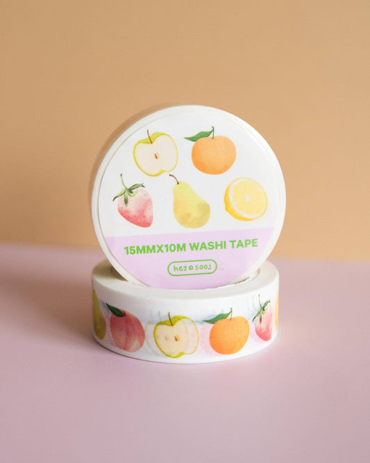 Washi tape with fruit design on a pink surface and beige background