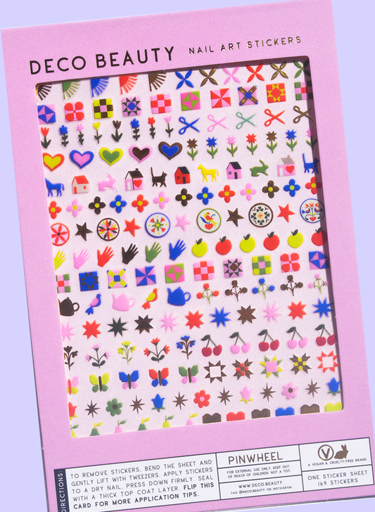 A package of Deco Beauty Nail Art Stickers, featuring a pink border and a clear window displaying a sheet of many colorful nail art motifs like flowers, hearts, stars, and hands.