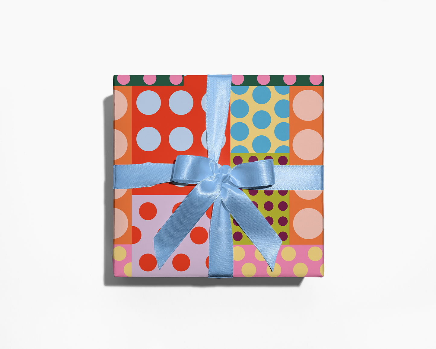 Colorful polka dot gift box with a blue ribbon on a white background