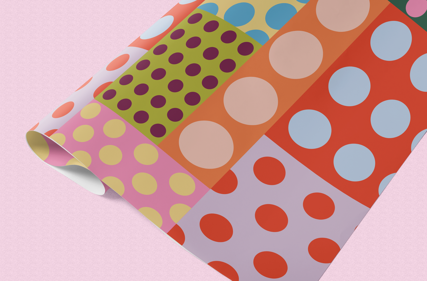 Colorful polka dot patterned paper on a pink background