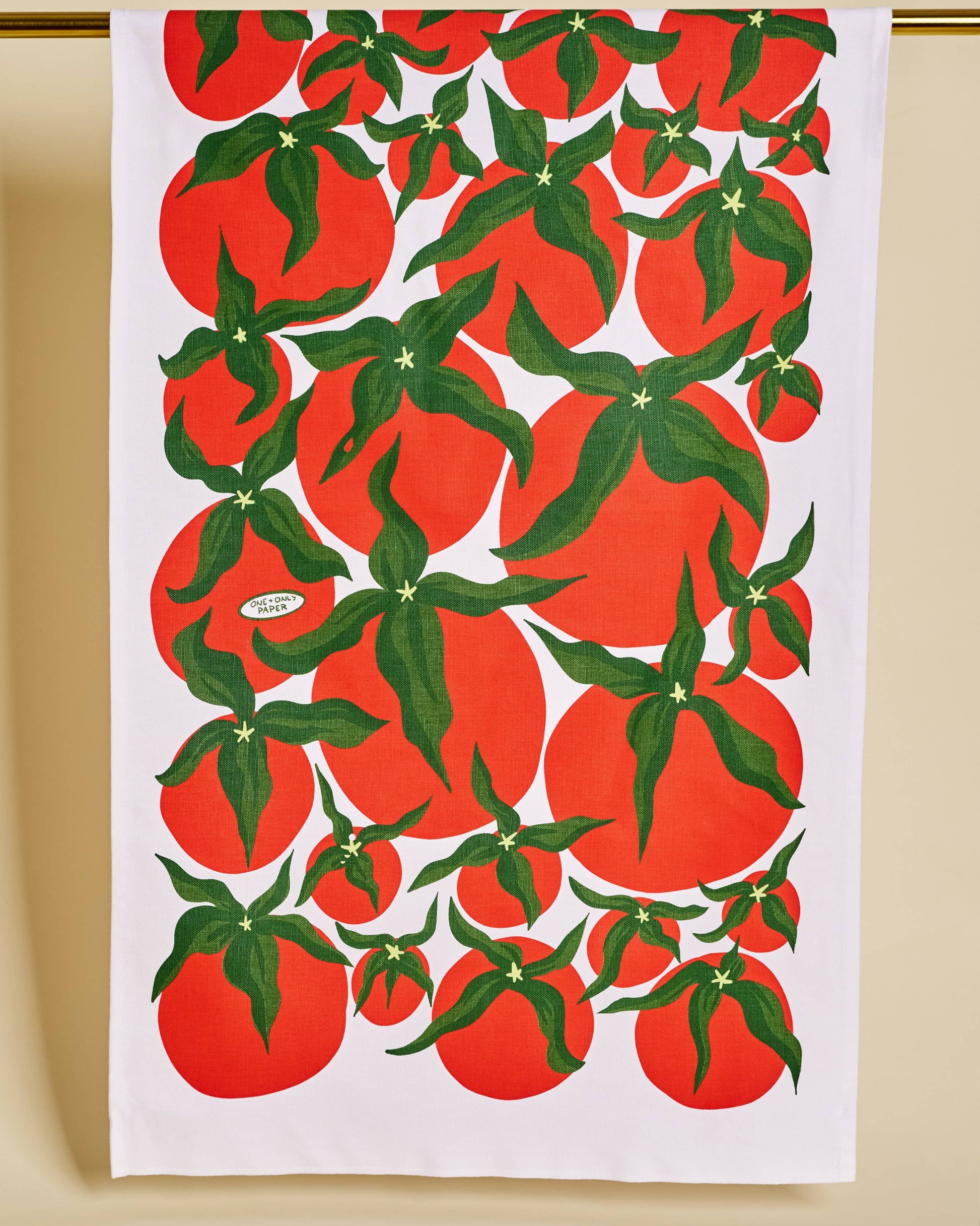 Tea towel with red tomato pattern on a white background