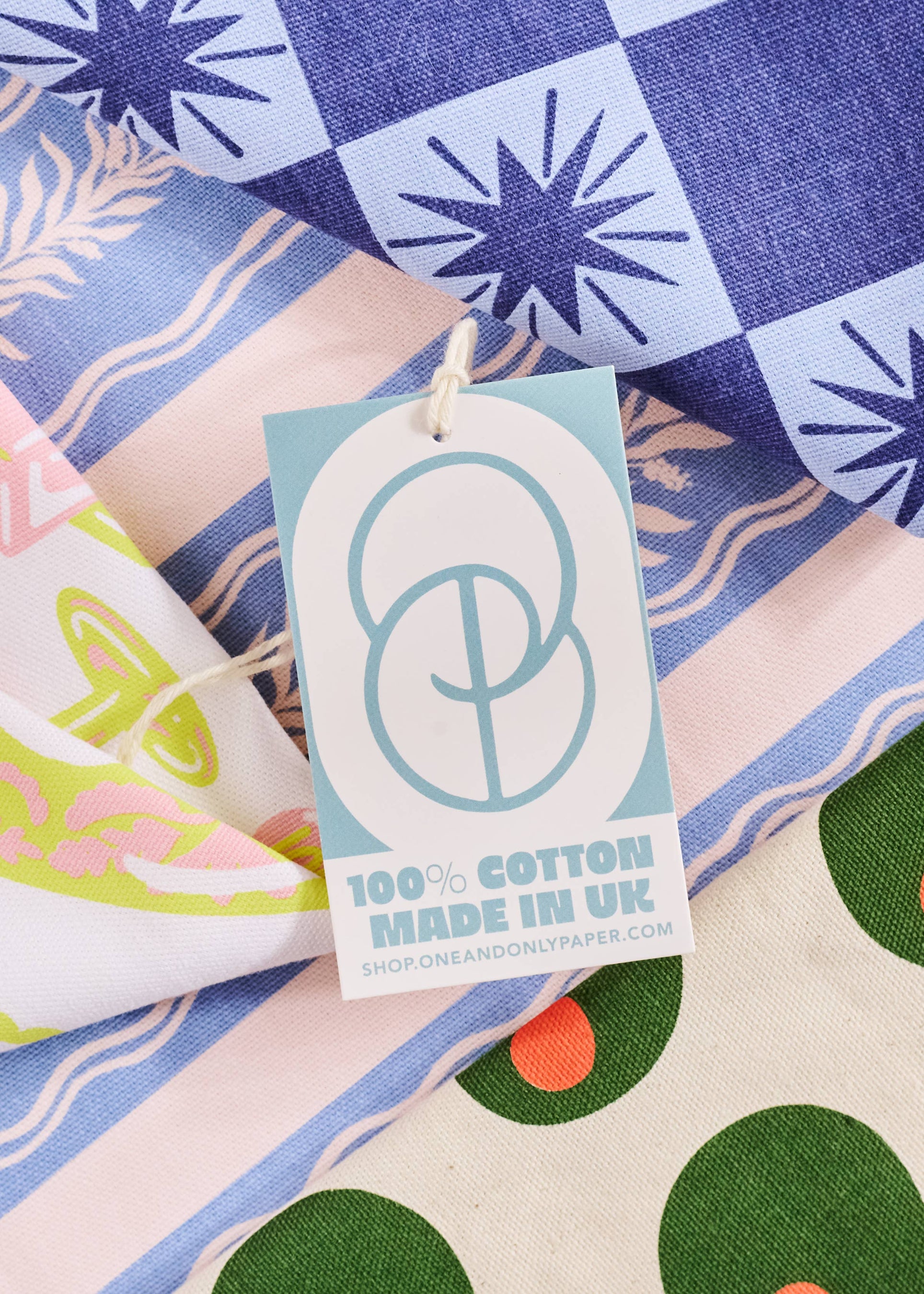 Product tag on a colorful fabric background with a checkered pattern
