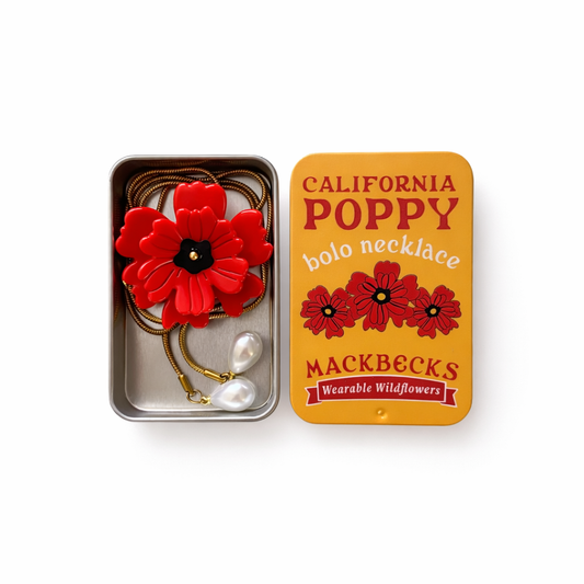 California Poppy bolo necklace in a Mackbecks branded box on a white background