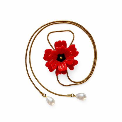 Necklace with a red flower pendant and pearl drops on a white background