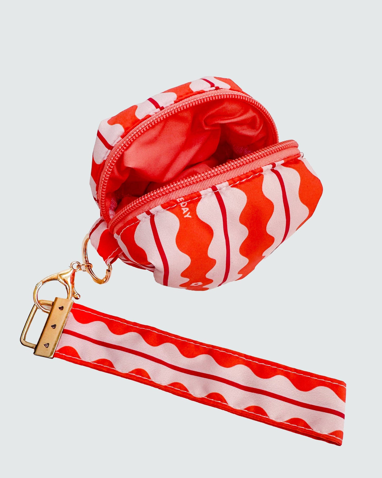 Red and white striped pouch with matching strap on a light gray background